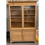 Late Victorian farmhouse pine two stage kitchen cabinet, the moulded cornice above two glazed doors,