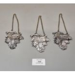 Matching set of three repousse vine leaf design decanter labels and chains, 'Whiskey', 'Porto'