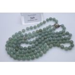 A double strand green hardstone necklace with stone set 800 silver clasp. (B.P. 21% + VAT)