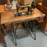 Early 20th century oak cases Singer sewing machine on stand with cast iron base. (B.P. 21% + VAT)