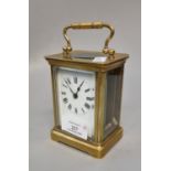 Early 20th century brass carriage clock with enamel face and Roman numerals, with key. (B.P. 21% +