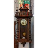 Early 20th century walnut two train presentation Vienna type wall clock, with key and pendulum. (B.