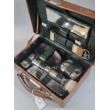 Small gentleman's leather travelling shaving case with plated metal brush and accessories. (B.P. 21%