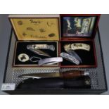 Assorted clasp knives, sheath knife and two collector's knifes in original boxes. (5) (B.P. 21% +