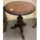 Victorian design mahogany lamp table, the circular moulded and carved top above an ornately carved