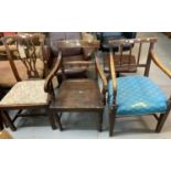 Two similar early 19th century oak elbow chairs, one with stick back one with ball and rail back,
