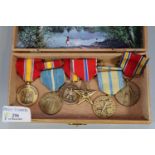 Wooden cigar box containing assorted USA military medals: 1939-45 War Medal, Bronze Star, Defence