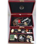 Red jewellery case containing assorted costume jewellery: pendants, bangles, brooches, hardstone