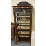 Edwardian ornately carved mahogany single door glazed display cabinet with under tier on square