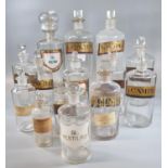 A group of assorted clear glass chemist jars with various labels, all with stoppers. (13) (B.P.