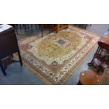 Modern Persian design floral and foliate rug on a beige ground with central flowerhead medallion.