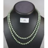 A double strand green hardstone necklace with stone set 800 silver clasp. (B.P. 21% + VAT)