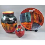 Three items of Poole pottery to include: Gemstones design shallow bowl, Harlequin design baluster