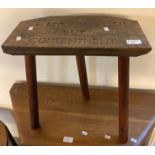 Rustic elm and stained stool with the motto carved 'Not Wealth but Contentment'. (B.P. 21% + VAT)