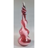Ruby wrythen combed glass triple baluster shaped decanter with blown stopper. 36cm high approx. (B.