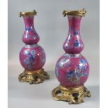 Pair of late 18th/early 19th Century puce ground baluster shaped bottle vases with rococo style