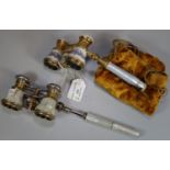 Two pairs of French opera glasses, one mother of pearl finish, the other with floral enamel