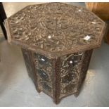 Early 20th century ornately carved octagonal folding lamp table, carved overall with leaves and