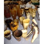 Two trays of vintage and antique horn beakers, two with silver mounts, together with four horn