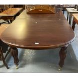 Victorian style mahogany extending dining table with one additional leaf on fluted legs and brass