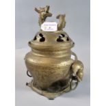 Chinese brass lidded censer with dragon knop to the pierced cover and elephant loop handles, on