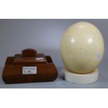 Large Ostrich egg, together with a wooden lidded box in the form of a stylised tank. (B.P. 21% +