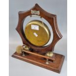 Brass gong with striker on metal mounted wooden stand. 28cm high approx. (B.P. 21% + VAT)