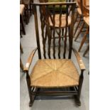 1930s stained slat backed rocking low nursing chair with seagrass seat. (B.P. 21% + VAT)