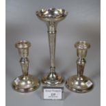 Pair of silver dwarf candle sticks together with a silver trumpet vase with loaded base. (3) (B.P.
