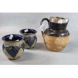 Doulton Lambeth stoneware Harvest Topers jug with silver collar together with a pair of Doulton