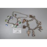 A silver charm bracelet with various charms including a spinning wheel, rocking chair, clock etc.