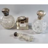 Two similar cut glass globular scent bottles with silver lids together with another Edwardian design
