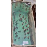 Cased diorama with glass top, the interior depicting toy battle scene. 42x19x13cm approx. (B.P.