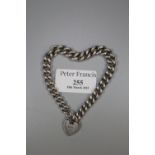 A silver curb link charm bracelet with heart shaped clasp. Approx weight 34.9 grams. (B.P. 21% +