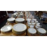 Six trays of Noritake 'Balmoral' dinner ware, gold patterned rims on a white ground: twelve place