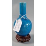 Small Chinese porcelain baluster vase on a stand with a scrolling lotus motif on a turquoise