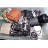 Box of photographic equipment: Nikon FM SLR camera with Vivitar zoom lens, Nikon 50mm lens, Pentax