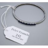 White metal and blue stone bangle. Approx weight 11.8 grams. (B.P. 21% + VAT)