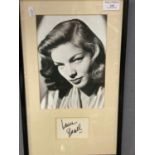 Framed black and white photograph of the actress Lauren Bacall with her signature , certificate