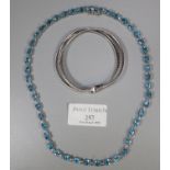 A silver and blue topaz necklace and a silver triple row bracelet. Approx weight 60 grams. (B.P. 21%