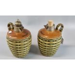 Two stoneware brandy and whisky jugs with silver plated collars, wicker handle and body. (2) (B.P.