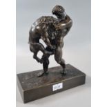 After the antique, good quality patinated bronze figure of a muscular man fighting a male lion, on