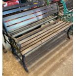 Pair of weathered and slatted garden benches with cast metal scroll decorated bench ends. (2) (B.