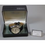 Quartz Seiko chronograph with triple buttons, cream face with Arabic numerals and date aperture on