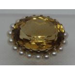 Citrine and pearl brooch. The large oval citrine approx 23x18mm surrounded by nineteen cultured