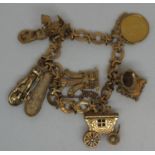 A yellow metal charm bracelet with five 9ct gold charms and an 1887 gold half sovereign. Approx
