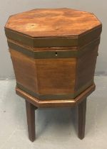 Georgian mahogany octagonal cellarette/wine cooler, the shaped top with ebonised inlay with brass
