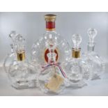 Five similar Remy Martin Baccarat glass cognac decanters and stoppers, together with a larger fine