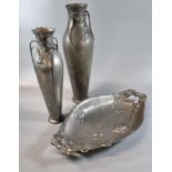 Two similar Kayserzinn Art Nouveau pewter vases with floral swing handles and raised organic