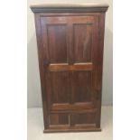 18th century oak single door blind panelled vestment cupboard, the moulded cornice above blind